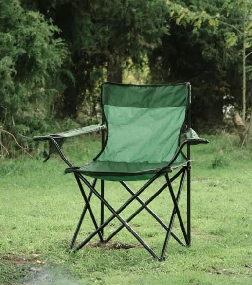 An empty camping chair on grass at the edge of a festival field — a volunteer who did not turn up.