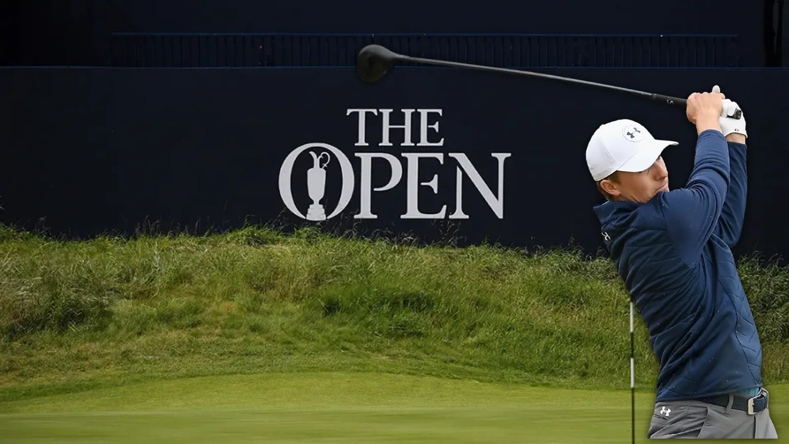 A golfer mid-swing in front of The Open's greenside sign at Royal Portrush
